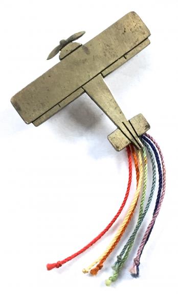Biplane aircraft 1978 hm silver badge with coloured tail streamers