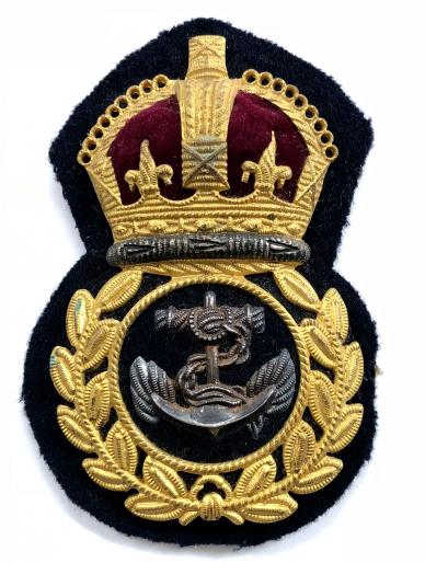 Royal Navy Chief Petty Officer gilt metal economy issue cap badge.