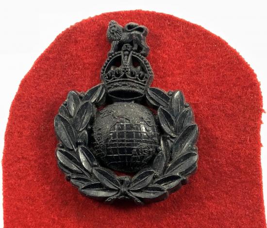 WW2 Royal Marines plastic economy issue badge on red felt backing